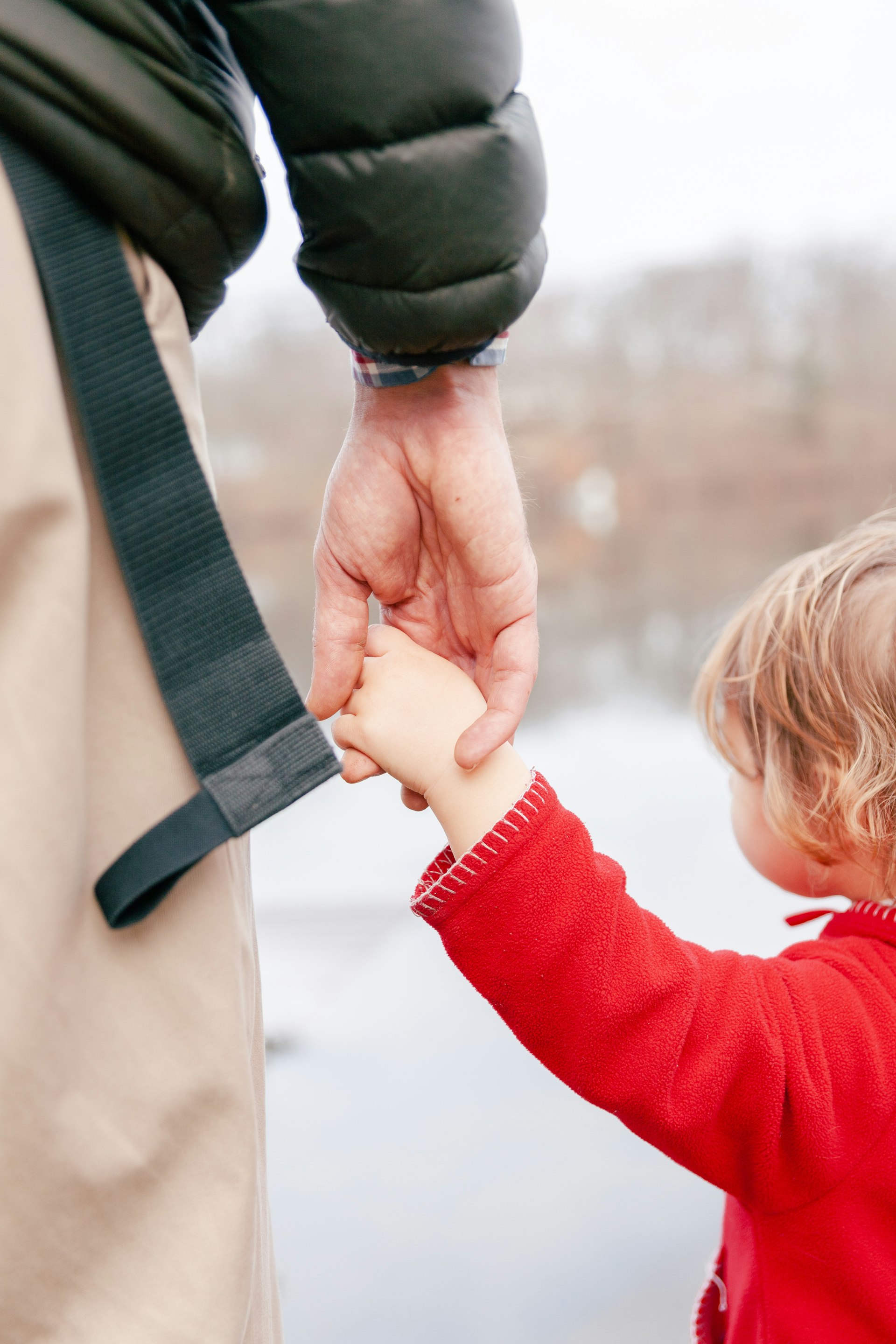 A father holding his child's hand